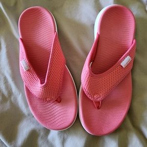 Pink and white flip flops